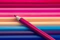Pink color pencil on many colorful pencils background Royalty Free Stock Photo