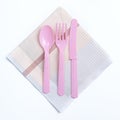 Pink color plastic fork, spoon and knife on napkin Royalty Free Stock Photo