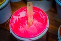 pink color of plastisol ink in white plastic barrel.