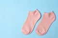 The pink color short socks on light blue background with copy space Royalty Free Stock Photo