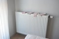 pink color socks drying on heating radiator,