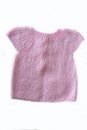 A pink color soft baby sweater over white