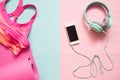 Pink color sport bra and yoga mat with smartphone and earphones Royalty Free Stock Photo