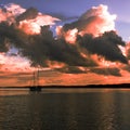 Pink colored cumulonimbus cloud, sunset seascape. Royalty Free Stock Photo