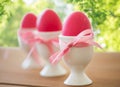 Pink colored easter eggs in holders on table Royalty Free Stock Photo