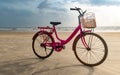 Pink Colored Old Ladies Bicycle Parked On  Beach After Cycling. A Fun Filled Healthy Activity And Must To Do On Beach