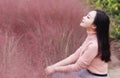 Happy closed eyes Asian Chinese woman girl feel freedom sweet dream pray flower field autumn fall park grass lawn hope nature Royalty Free Stock Photo