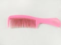 Pink comb made from plastic isolated on white background Royalty Free Stock Photo