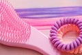 Pink comb, purple bright hair. Decoration for teenage girls. Silicone rubber band Royalty Free Stock Photo