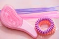 Pink comb, purple bright hair. Decoration for teenage girls. Silicone rubber band Royalty Free Stock Photo