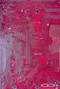 Pink computer circuit board. Hardware components. Close-up, background.