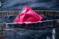 Pink condom in the pocket of blue jeans Royalty Free Stock Photo