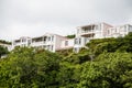 Pink Condos Over Green Shrubs Royalty Free Stock Photo