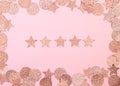 Pink confetti in the shape of a star on a pink background. Christmas and New Year concept. Festive award or rating concept. Five