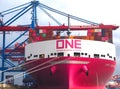 Pink container ship ONE inspiration of the shipping company Ocean network express at terminal Burchardkai at the port oh Hamburg