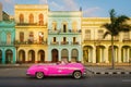 Pink convertible car and colorful buildings in Havana