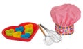 Pink cooking hat, with multi-colored pattern, hearts, flowers and owls. Hearts molds for cookies in red. Whisk to froth. Royalty Free Stock Photo