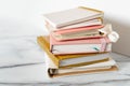 Pink coral colored diary for the year 2024 and many other diaries, pen, marble background Royalty Free Stock Photo