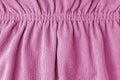 Pink velveteen fabric with folds on elastic. Cloth background, velveteen texture. Royalty Free Stock Photo