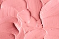 Soft pink cosmetic clay facial mask, cream texture close up, selective focus. Abstract background with brush strokes. Royalty Free Stock Photo