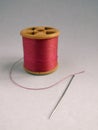 Pink Cotton reel, thread and needle Royalty Free Stock Photo