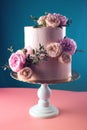 Pink cream wedding cake decorated with fresh roses Royalty Free Stock Photo