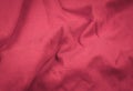 Pink crinkled fabric with visible details. background