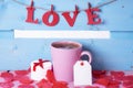 Coffee cup with a gift and the word love Royalty Free Stock Photo