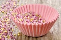 Pink cupcake case with sugar sprinkles