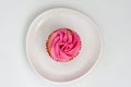 Pink cupcake on a plate isolated on white background. Delicious cake. Top view Royalty Free Stock Photo