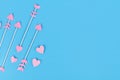 Pink cupid`s arrows with heart shaped tips on blue background Royalty Free Stock Photo