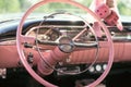 The pink dashboard and steering wheel of a classic car Royalty Free Stock Photo