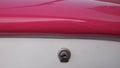 Pink dashboard and white glove compartment of a retro car