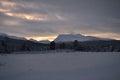 Pink dawn sky over frost ice and snowy winter forest and field Royalty Free Stock Photo