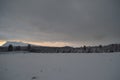 Pink dawn sky over frost ice and snowy winter forest and field Royalty Free Stock Photo