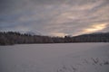 Pink dawn sky over frost ice and snowy winter forest and field Royalty Free Stock Photo