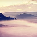 Pink daybreak in hilly landscape. Autumn misty morning in a beautiful rocky hills.