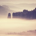 Pink daybreak in hilly landscape. Autumn misty morning in a beautiful rocky hills.