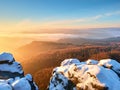 Pink daybreak in hilly landscape. Early winter misty morning in land