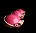 Pink desserts with raspberries and white chocolate decorations