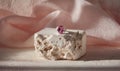 A pink diamond ring is on a white stone Royalty Free Stock Photo