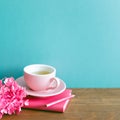 Pink diary, pencil, cup of tea, dry flowers on wooden table. mint blue wall Royalty Free Stock Photo