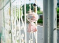 Pink doll hanging on the fence. It very sad.