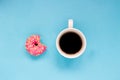 Pink donut with cup of coffee on the blue background. Royalty Free Stock Photo