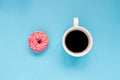 Pink donut with cup of coffee on the blue background. Royalty Free Stock Photo