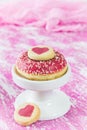 Pink donut with heart cookies on pink and white painted background Royalty Free Stock Photo