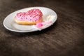Pink donut with icing lies on a white plate Royalty Free Stock Photo