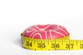 Pink donut and meter, the concept of weight gain and weight loss. Royalty Free Stock Photo