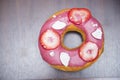 Pink donut with piece strawberry