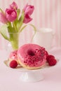Pink donut with raspberry and sugar sprinkles